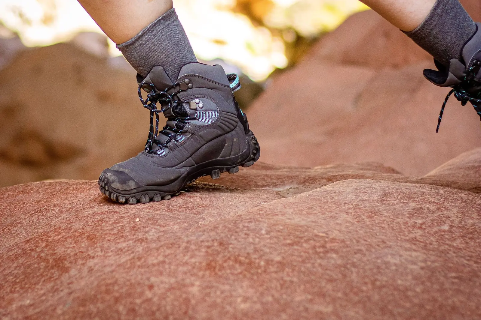 Hiking boot planted on red sandstone