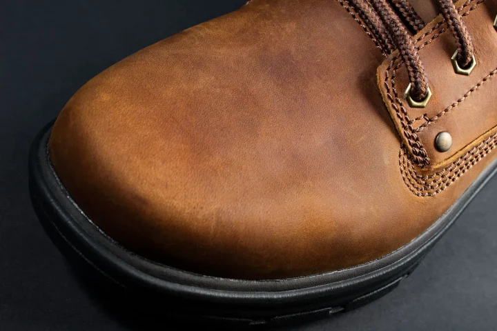 Close-up of a tan leather boot toe with stitching